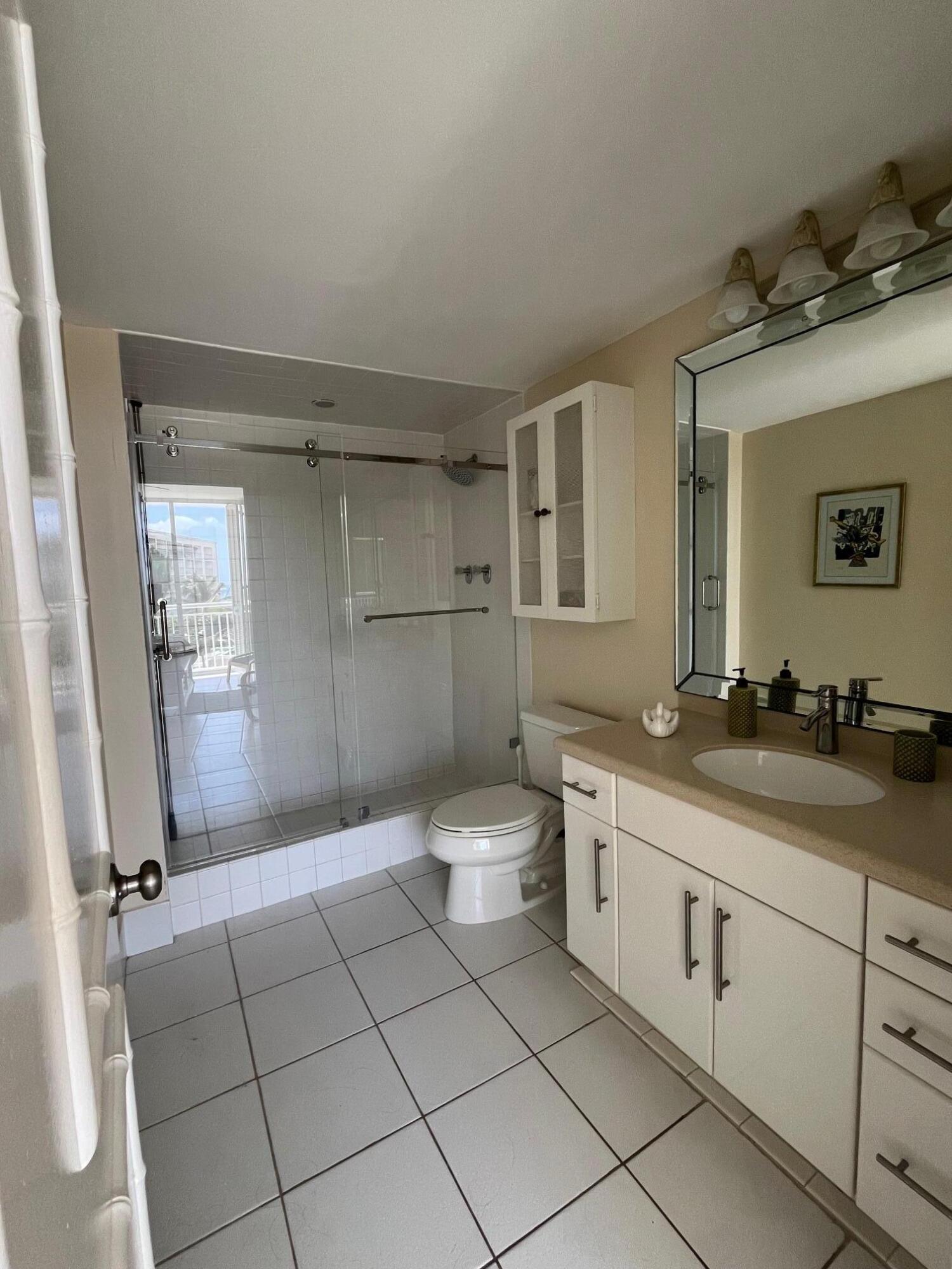 2780 South Ocean Boulevard, Unit 312 Palm Beach, FL 33480 - Photo 15 of 29 a spacious bathroom with a granite countertop sink a toilet and a mirror