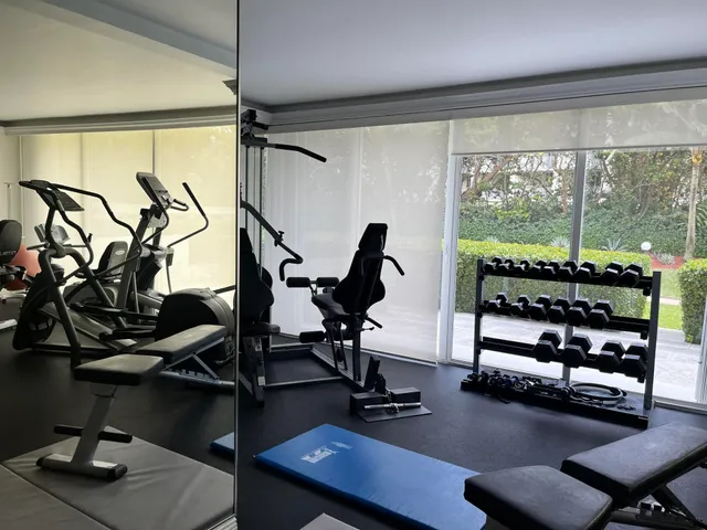 a room with gym equipment and windows