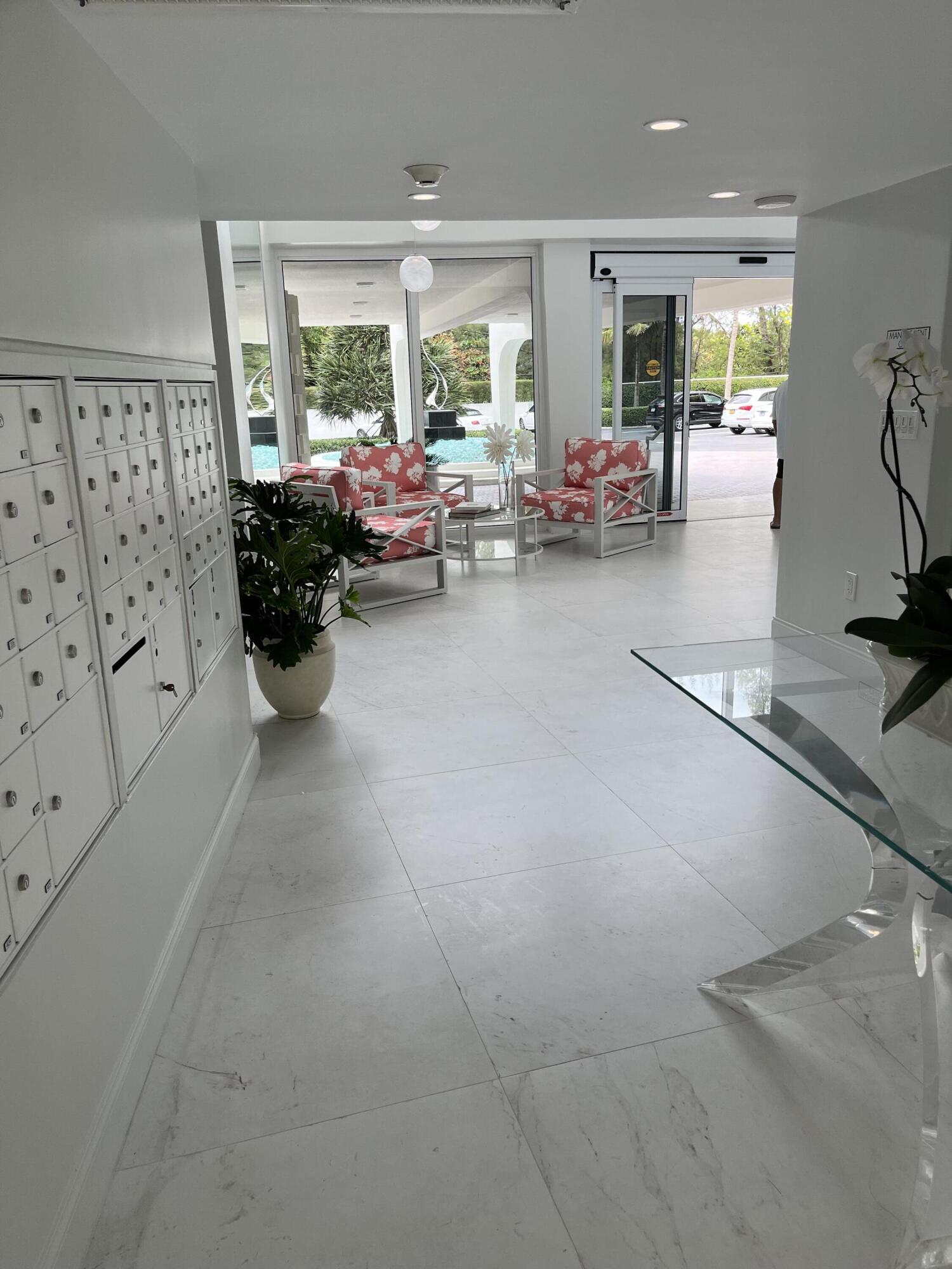 2780 South Ocean Boulevard, Unit 312 Palm Beach, FL 33480 - Photo 20 of 29 a living room with furniture large window and potted plants