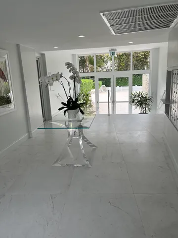 a view of a livingroom with furniture and floor to ceiling window