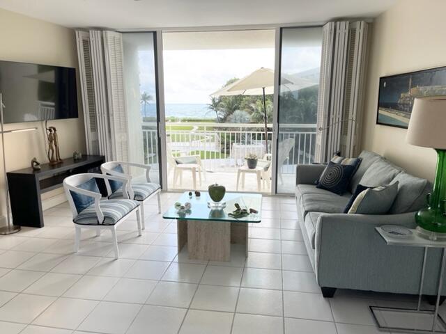 2780 South Ocean Boulevard, Unit 312 Palm Beach, FL 33480 - Photo 3 of 29 a living room with furniture and a flat screen tv