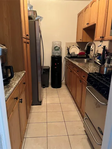 a kitchen with a sink appliances and cabinets