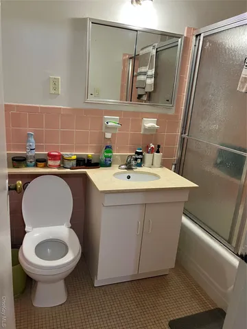 a bathroom with a sink a toilet and mirror