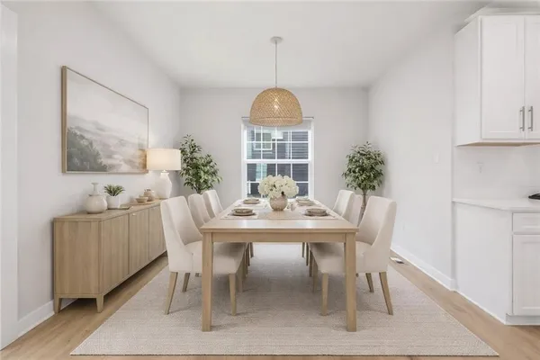 a view of a dining room with furniture window and wooden floor
