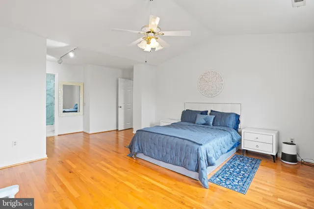 a bedroom with a bed chandelier and a window