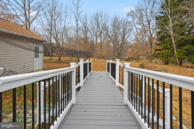 a view of a balcony with wooden floor and fence