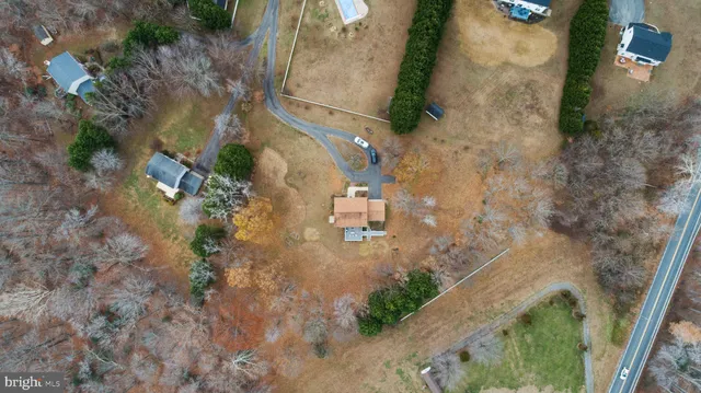an aerial view of a house with a yard