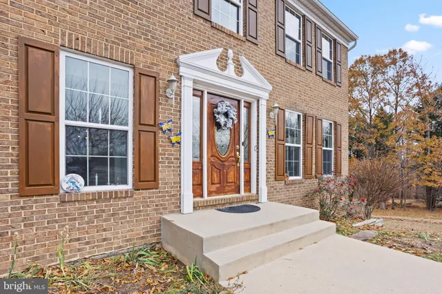 a front view of a brick house with a large windows