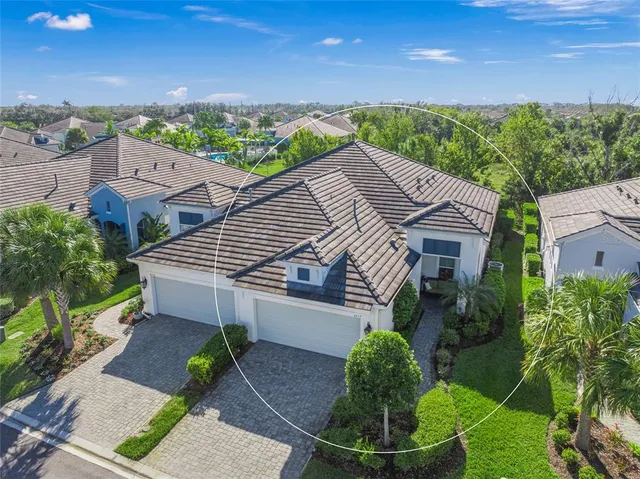 a aerial view of a house with a yard table and chairs