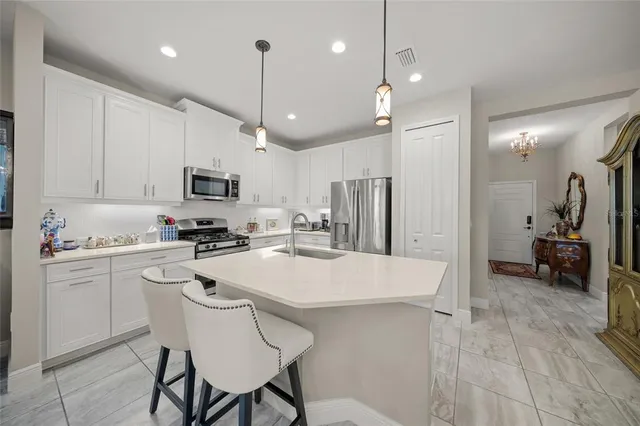 a kitchen with a stove a sink a dining table and chairs