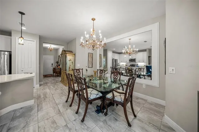 a view of a dining room with furniture and chandelier