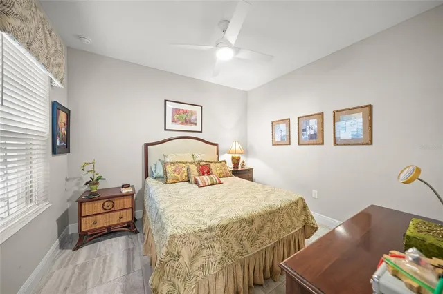 a bedroom with a bed and a lamp on dresser