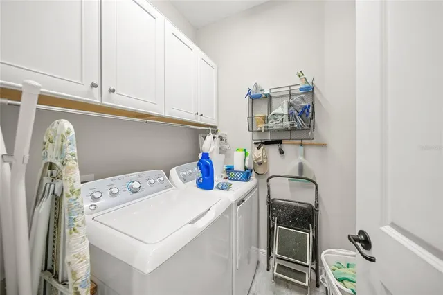 a view of a patio with table and chairs under an umbrella