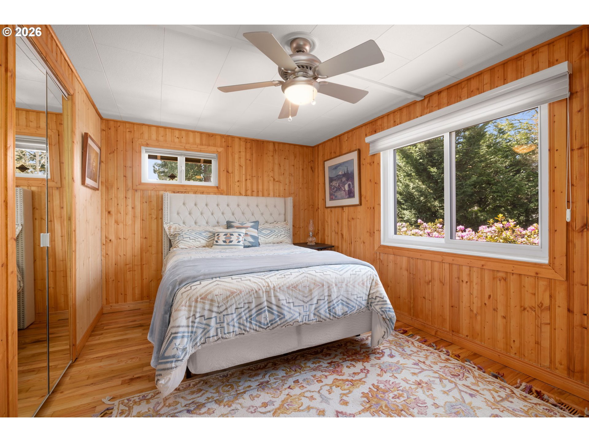 15880 Southeast Bluff Road Sandy, OR 97055 - Photo 20 of 47 a bedroom with a bed mirror and window