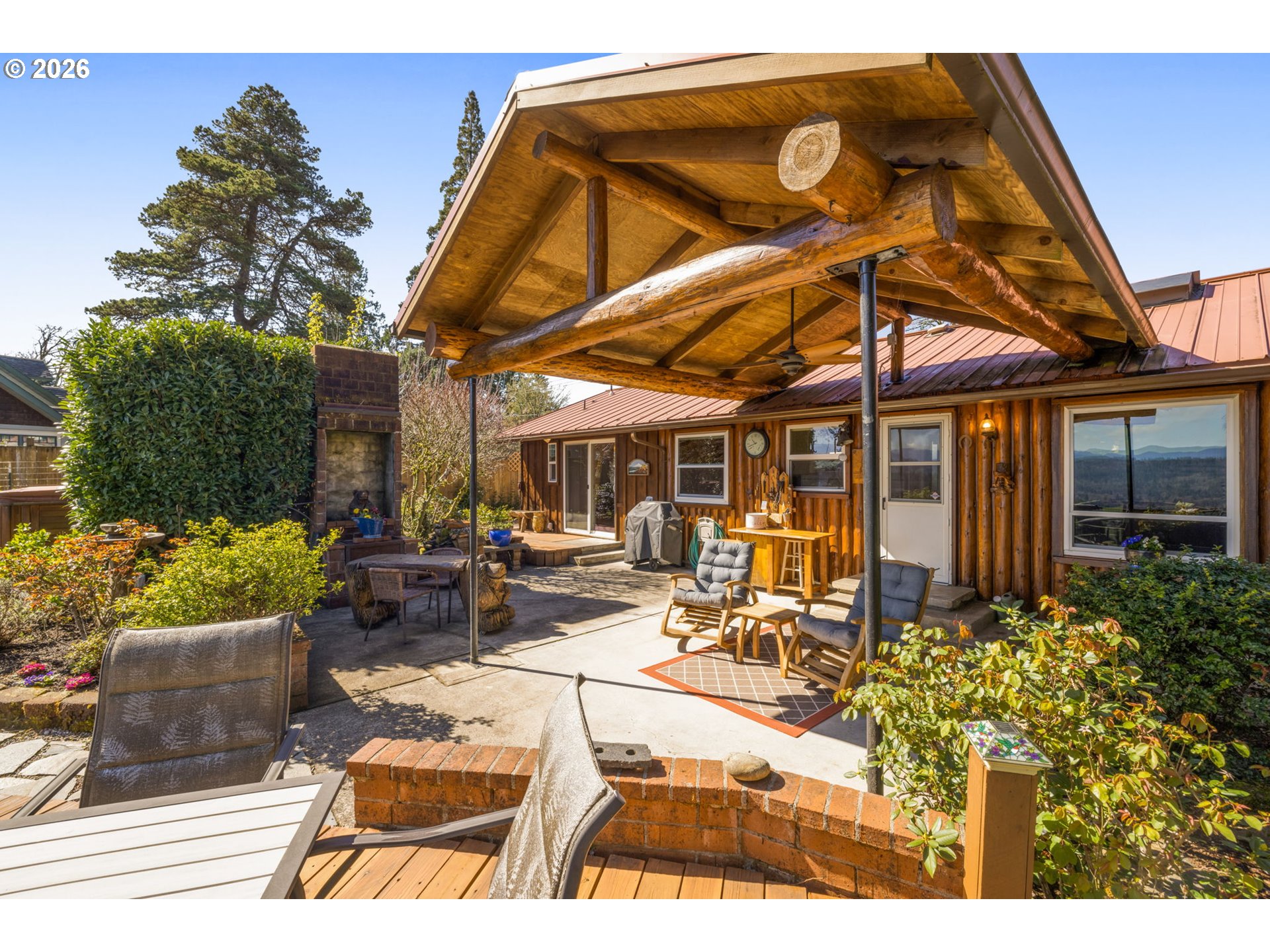 15880 Southeast Bluff Road Sandy, OR 97055 - Photo 2 of 47 a view of a patio with table and chairs and potted plants