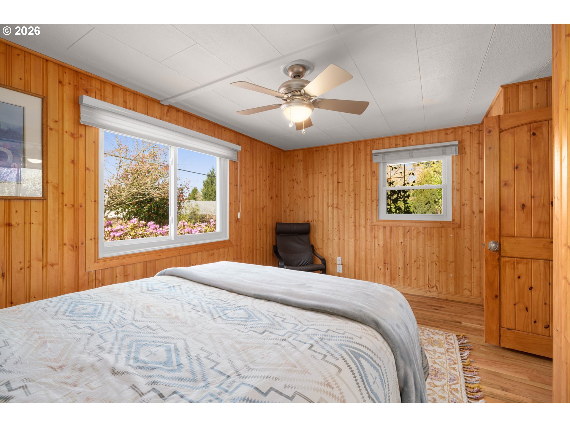 15880 Southeast Bluff Road Sandy, OR 97055 - Photo 21 of 47 a bedroom with a large bed and a chandelier