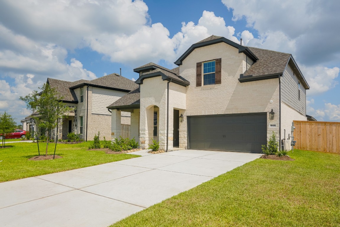 15135 Wild Gully Way Conroe, TX 77302 - Photo 1 of 42 a front view of a house with a yard and garage