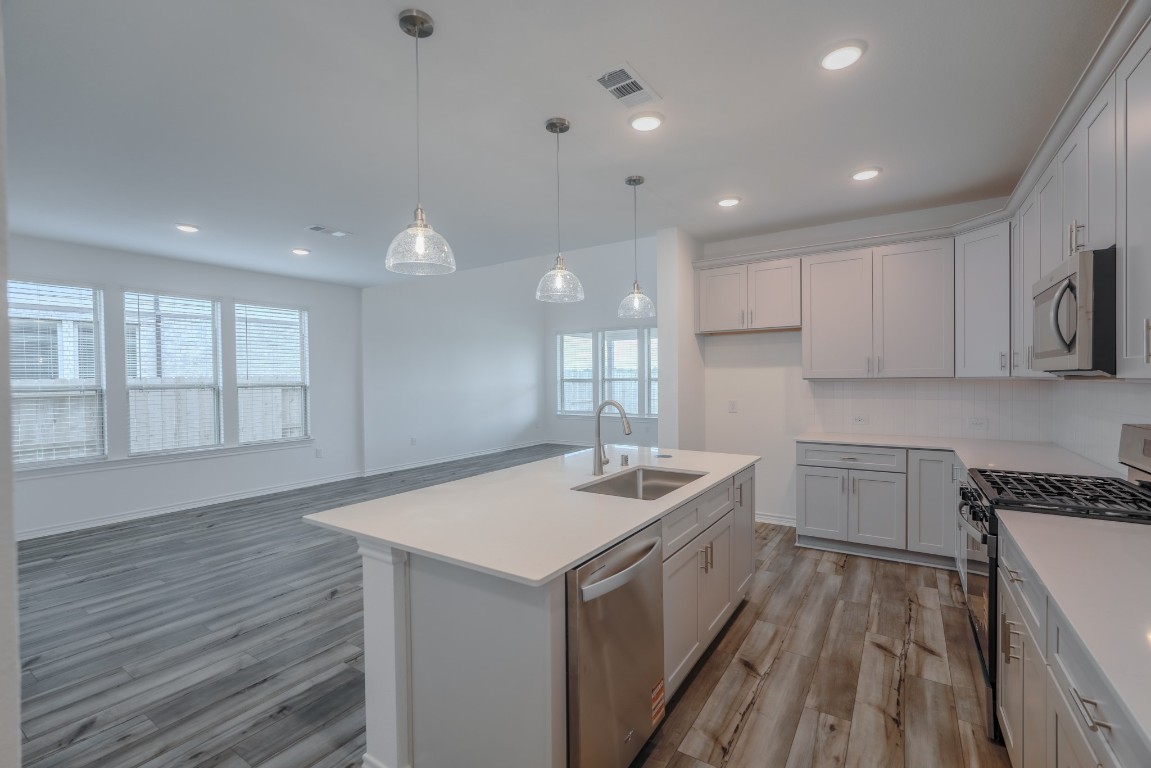 15135 Wild Gully Way Conroe, TX 77302 - Photo 15 of 42 a kitchen with a sink stove and cabinets