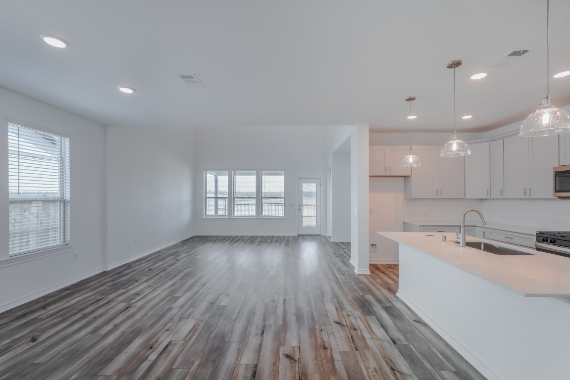 15135 Wild Gully Way Conroe, TX 77302 - Photo 16 of 42 a view of a kitchen with wooden floor and windows