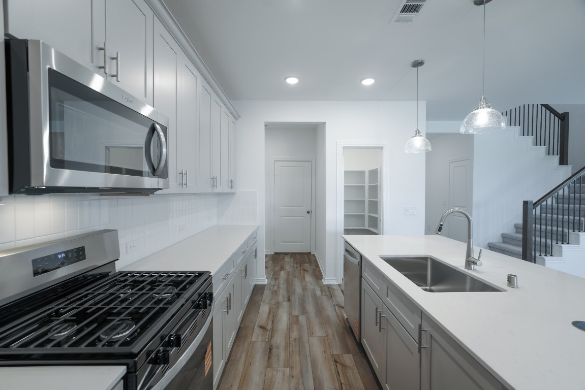 15135 Wild Gully Way Conroe, TX 77302 - Photo 18 of 42 a kitchen that has a sink and a stove