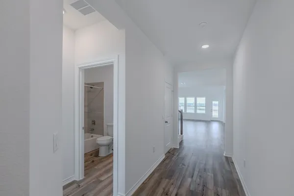 a bedroom with a bed and a lamp