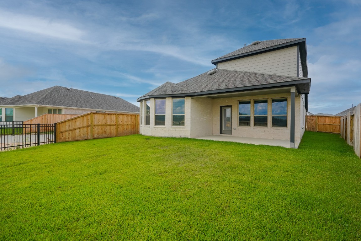 15135 Wild Gully Way Conroe, TX 77302 - Photo 35 of 42 a view of a house with a backyard