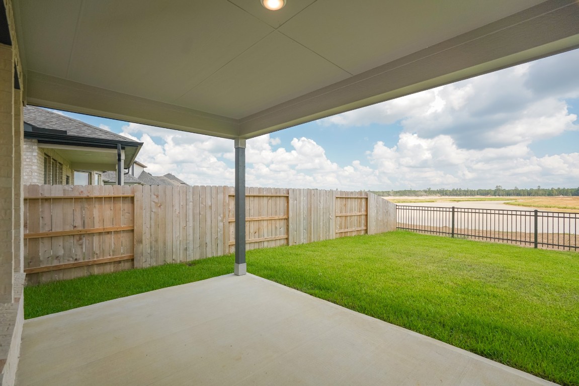 15135 Wild Gully Way Conroe, TX 77302 - Photo 36 of 42 a view of a porch with a yard