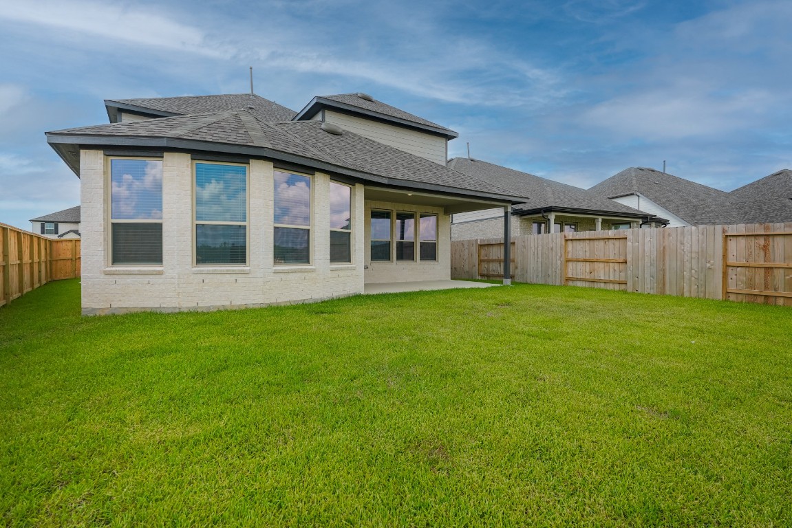 15135 Wild Gully Way Conroe, TX 77302 - Photo 38 of 42 a view of a house with a backyard