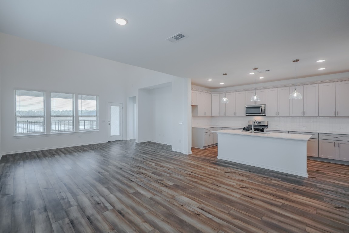 15135 Wild Gully Way Conroe, TX 77302 - Photo 8 of 42 a view of kitchen with wooden floor and window
