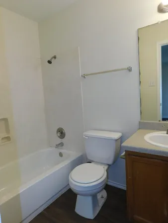a bathroom with a toilet a sink and a bathtub