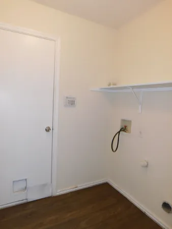 a view of a room with wooden floor