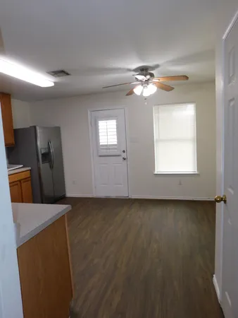 a view of a livingroom with a ceiling fan and window