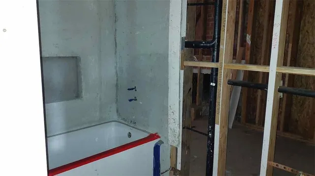 a bathroom with a tub and a shower