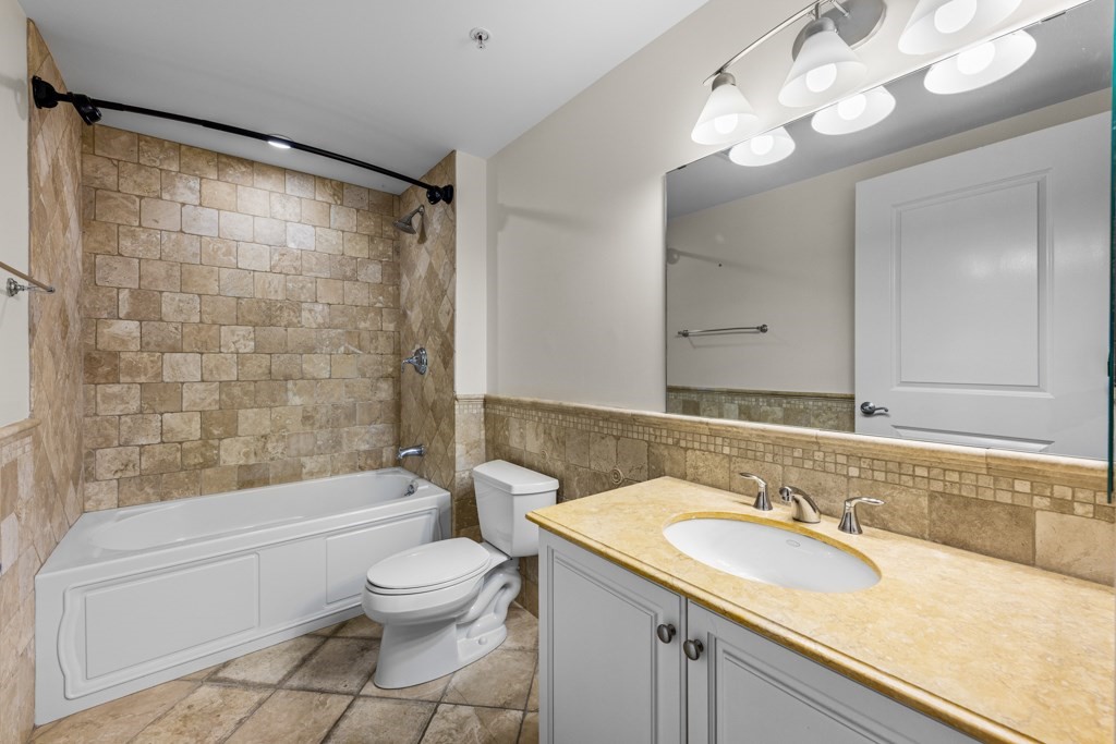 550 Pleasant Street, Unit 506 Winthrop, MA 02152 - Photo 16 of 21 a bathroom with a sink a toilet and shower