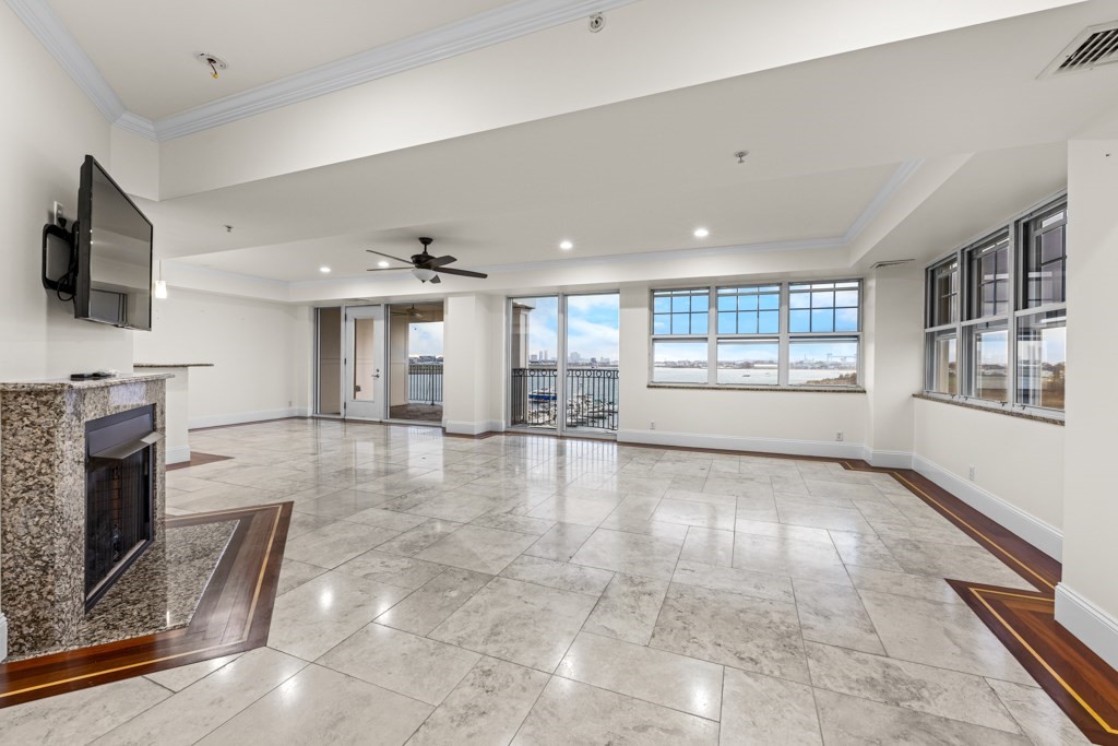 550 Pleasant Street, Unit 506 Winthrop, MA 02152 - Photo 2 of 21 a view of an empty room with a fireplace and a window