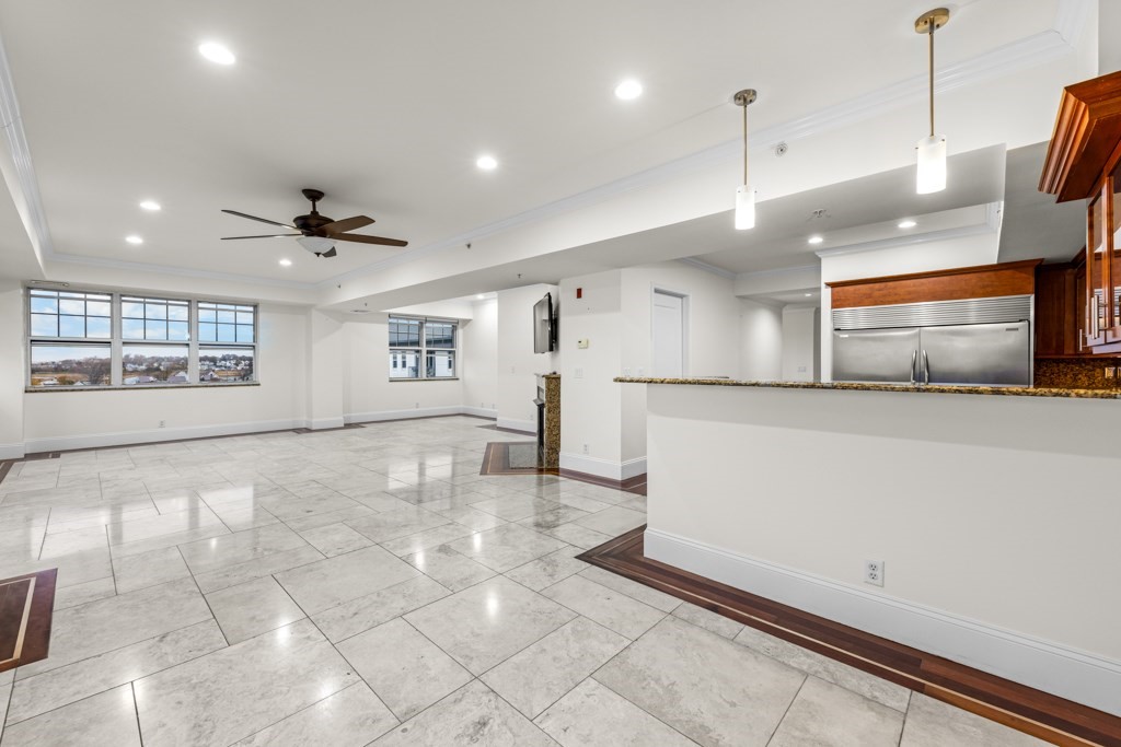 550 Pleasant Street, Unit 506 Winthrop, MA 02152 - Photo 7 of 21 a view of a kitchen with a sink and a stove top oven