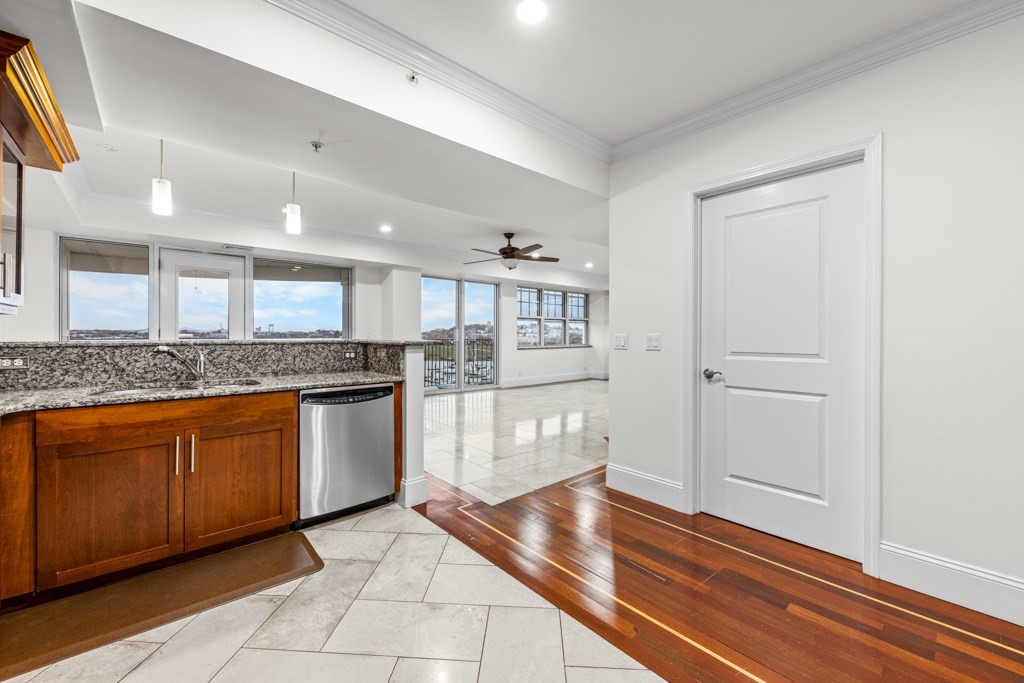 550 Pleasant Street, Unit 506 Winthrop, MA 02152 - Photo 8 of 21 a kitchen with granite countertop white cabinets and white appliances