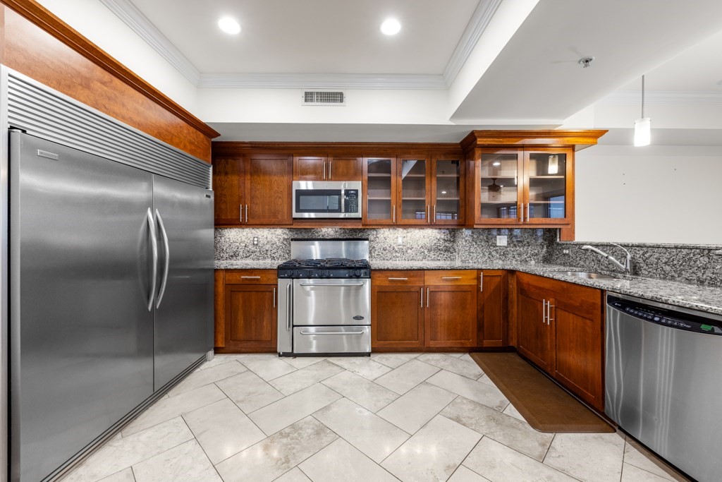550 Pleasant Street, Unit 506 Winthrop, MA 02152 - Photo 10 of 21 a kitchen with stainless steel appliances granite countertop a sink stove and refrigerator