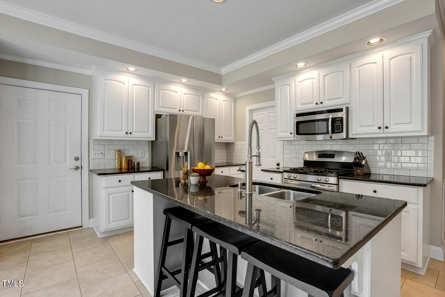 5809 Garrett Road Durham, NC 27707 - Photo 14 of 66 a kitchen with refrigerator cabinets and microwave