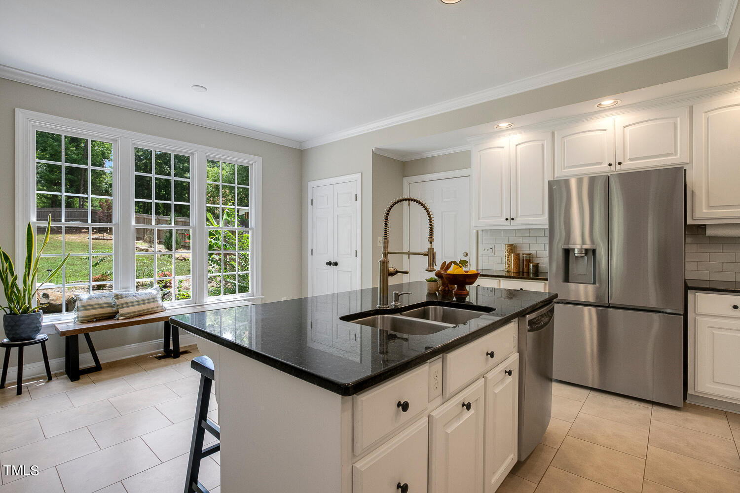 5809 Garrett Road Durham, NC 27707 - Photo 17 of 66 a kitchen with granite countertop a sink stove and refrigerator