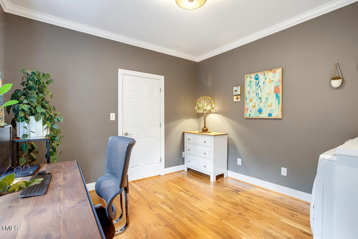 5809 Garrett Road Durham, NC 27707 - Photo 32 of 66 a workspace with furniture and a potted plant