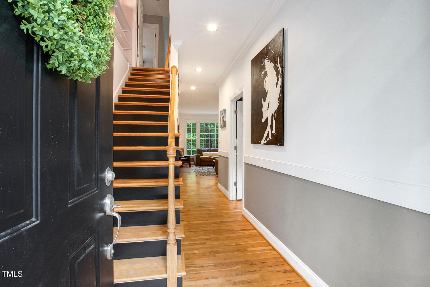 5809 Garrett Road Durham, NC 27707 - Photo 4 of 66 a view of a hallway with wooden floor and stairs
