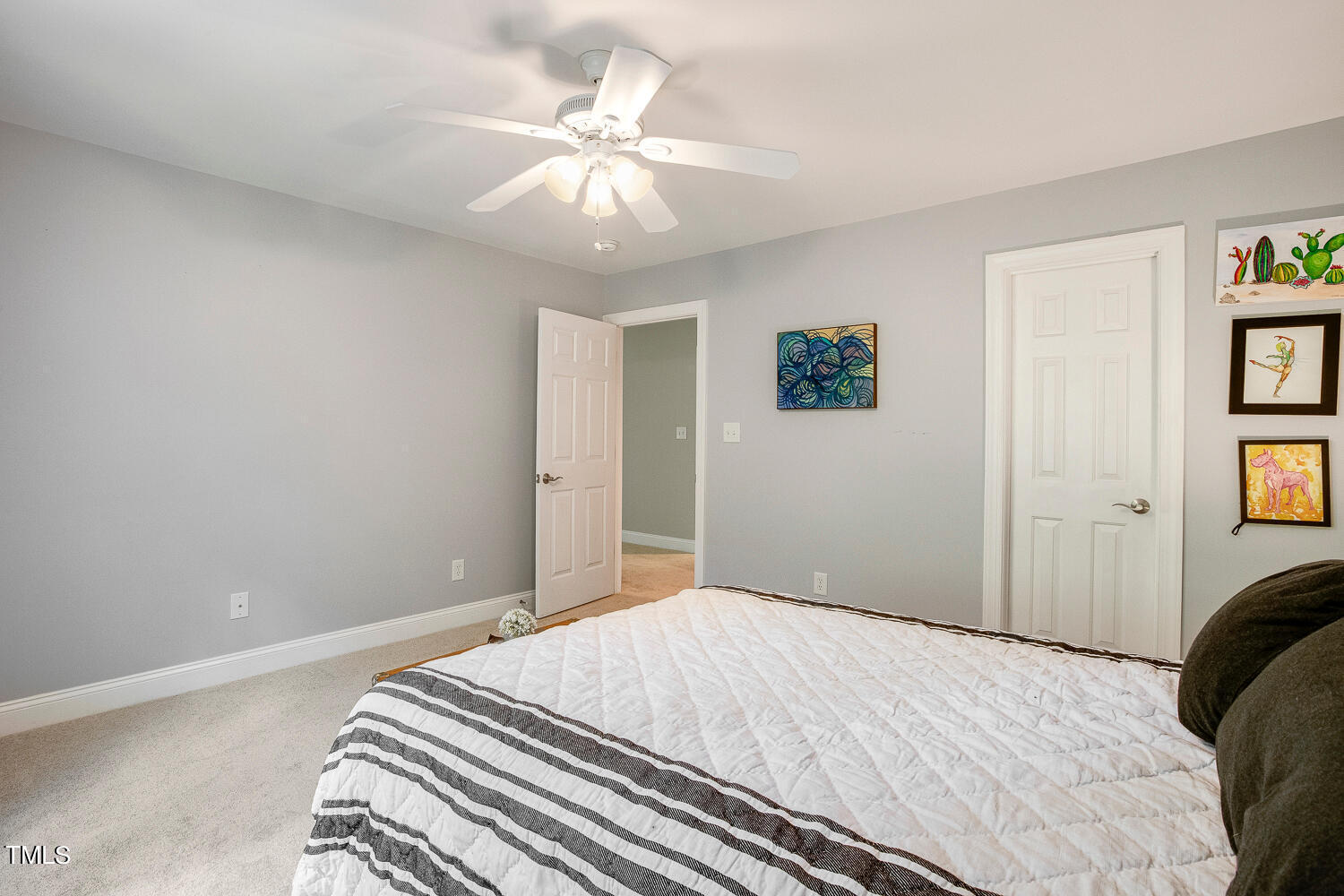 5809 Garrett Road Durham, NC 27707 - Photo 41 of 66 a bedroom with a bed and a chandelier