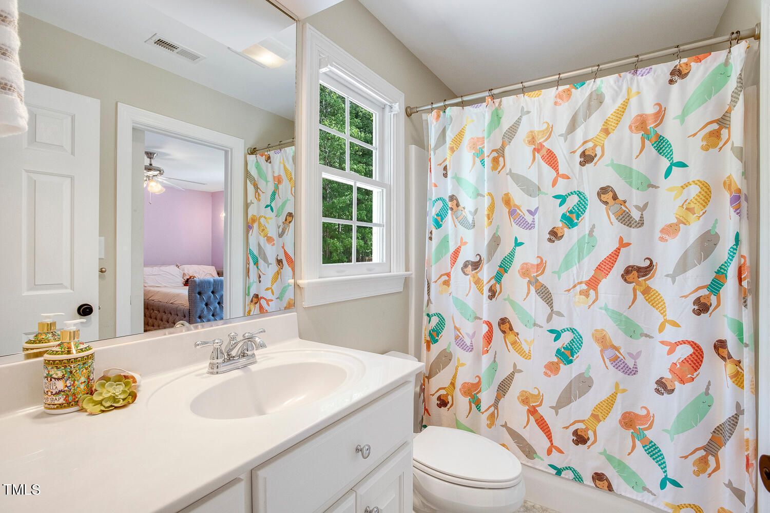 5809 Garrett Road Durham, NC 27707 - Photo 45 of 66 a bathroom with a sink toilet a mirror and shower curtain
