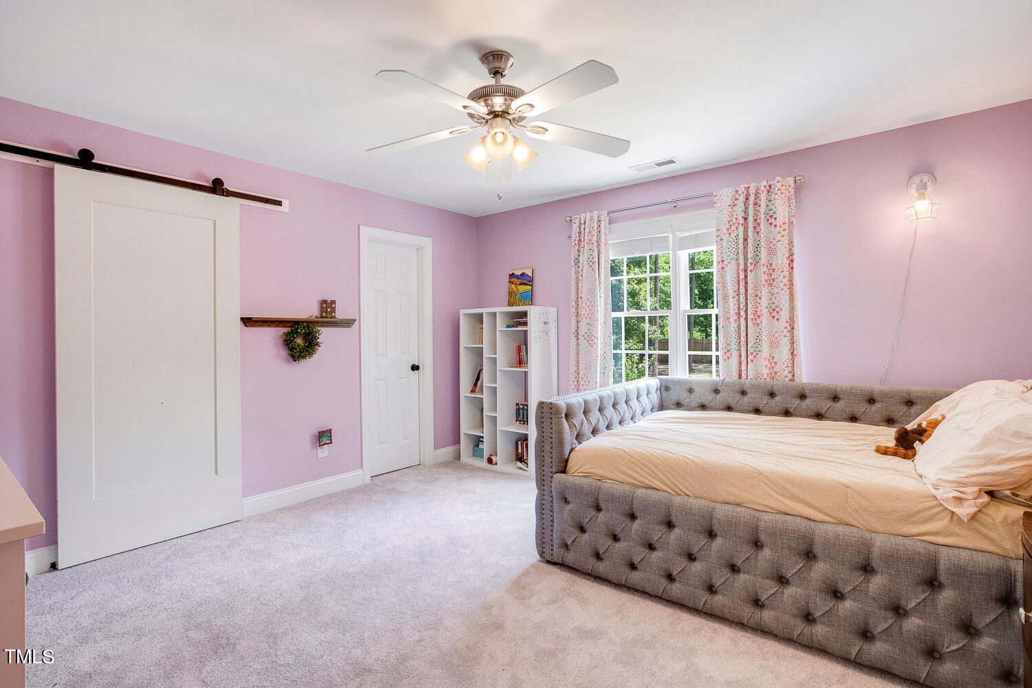 5809 Garrett Road Durham, NC 27707 - Photo 46 of 66 a bedroom with a bed and a chandelier