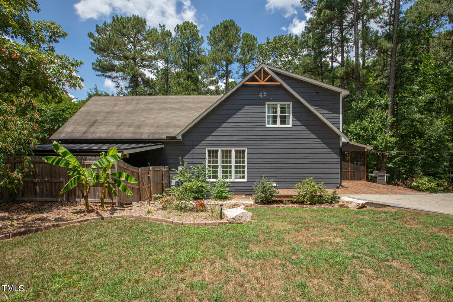 5809 Garrett Road Durham, NC 27707 - Photo 64 of 66 a backyard of a house with table and chairs