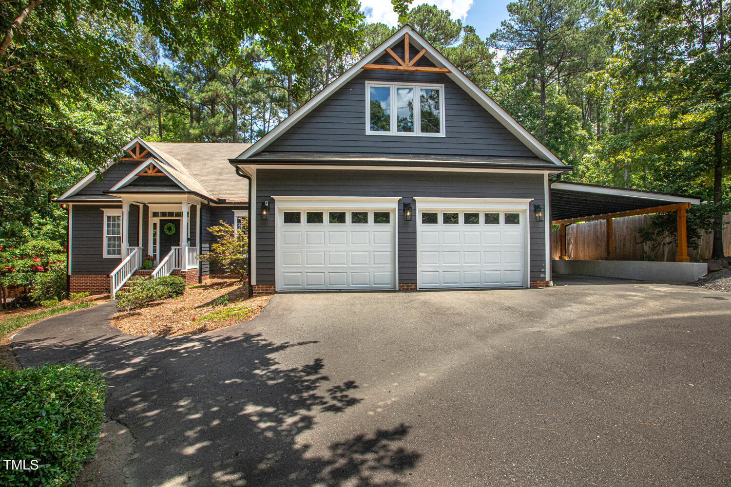 5809 Garrett Road Durham, NC 27707 - Photo 65 of 66 a front view of a house with a yard and garage