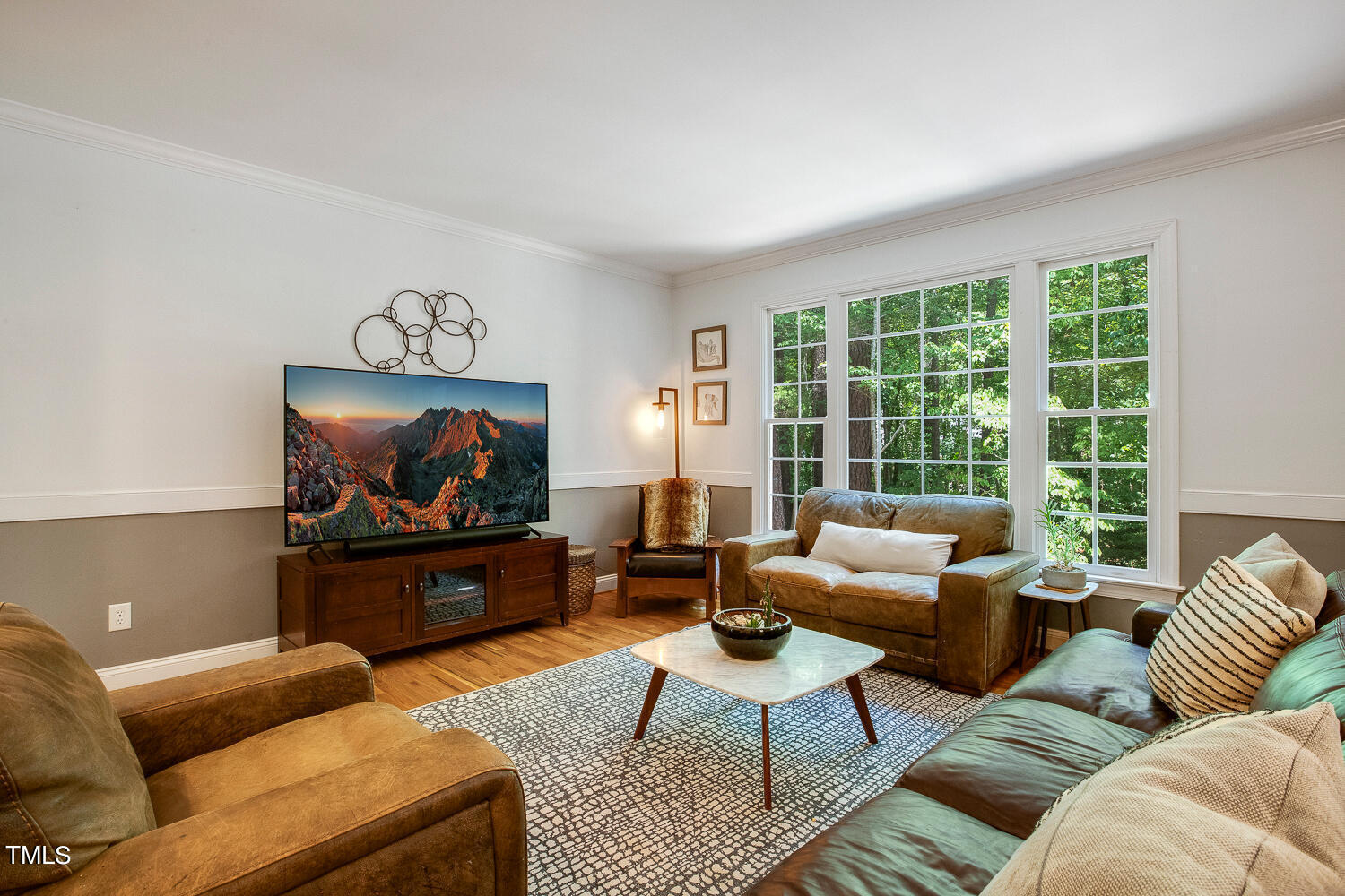 5809 Garrett Road Durham, NC 27707 - Photo 7 of 66 a living room with furniture a large window and a flat screen tv
