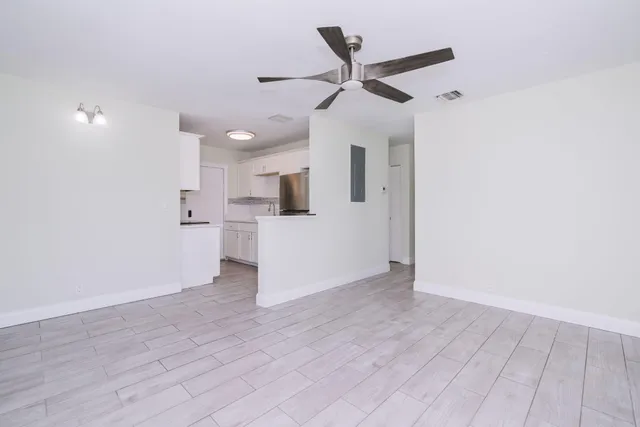 a view of a kitchen with a sink and a refrigerator
