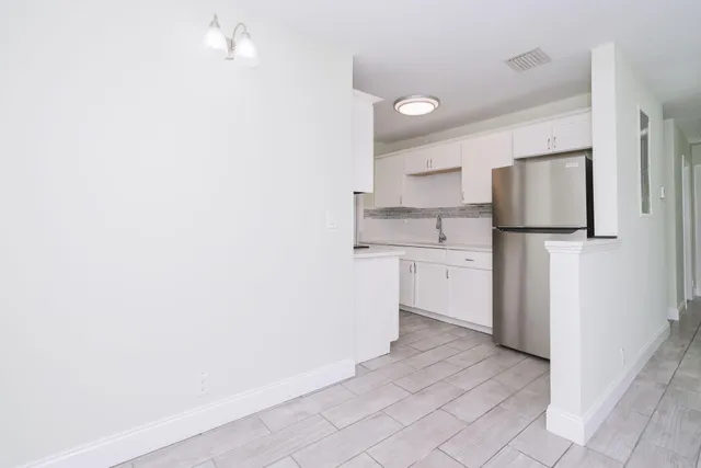 a kitchen with a sink cabinets and stainless steel appliances